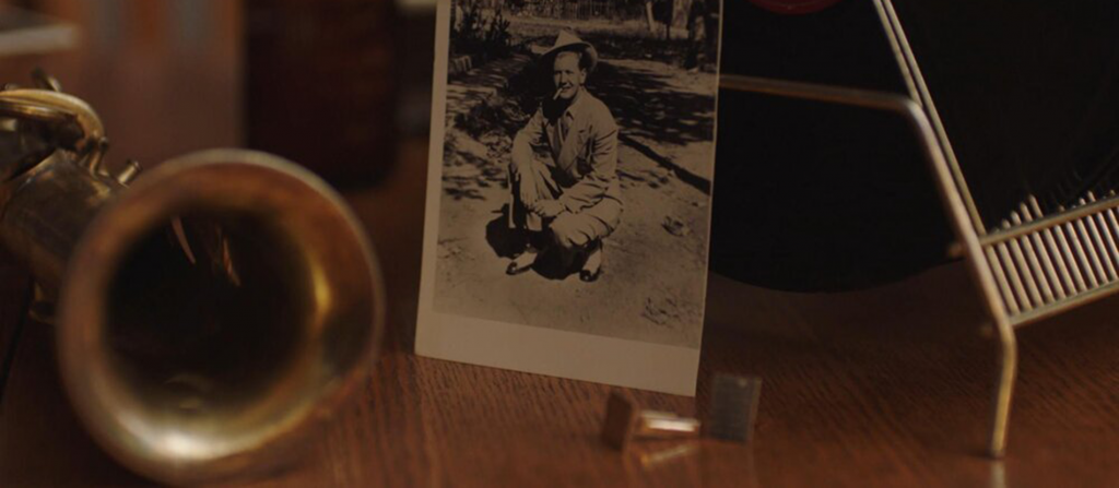 A photo of Billy Tipton sitting on a table in a still from No Ordinary Man