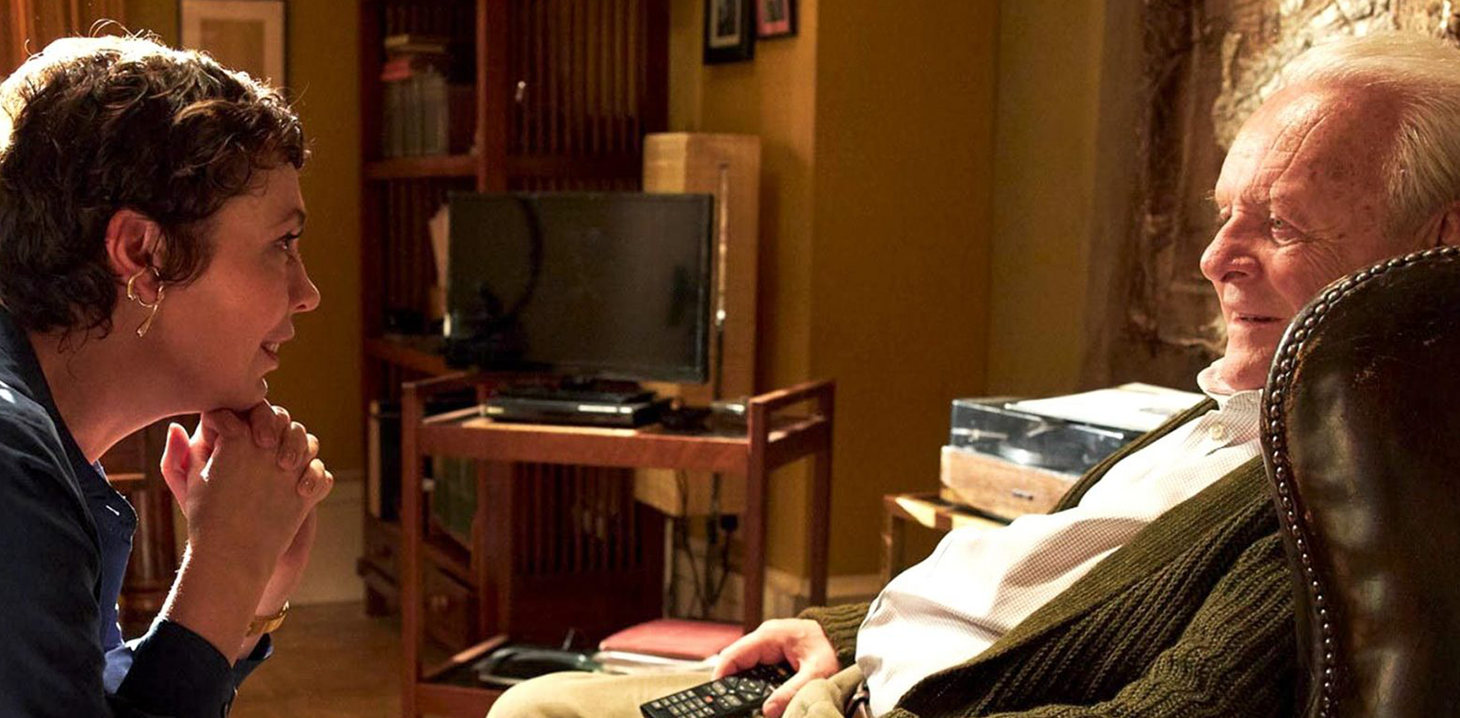 Olivia Colman and Anthony Hopkins seated opposite each other in The Father