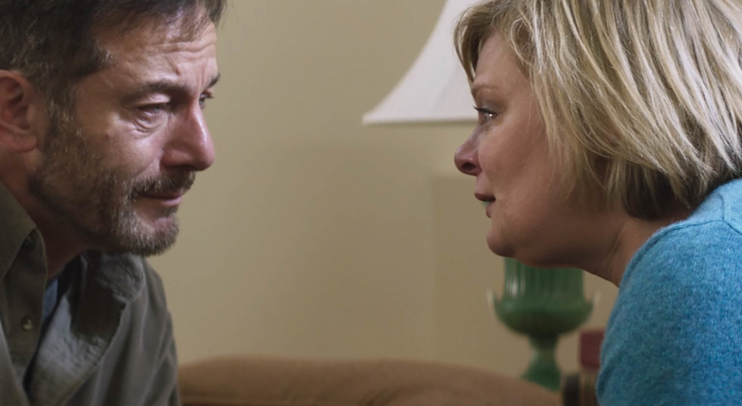 Jason Issacs sits across from Martha Plimpton in Mass