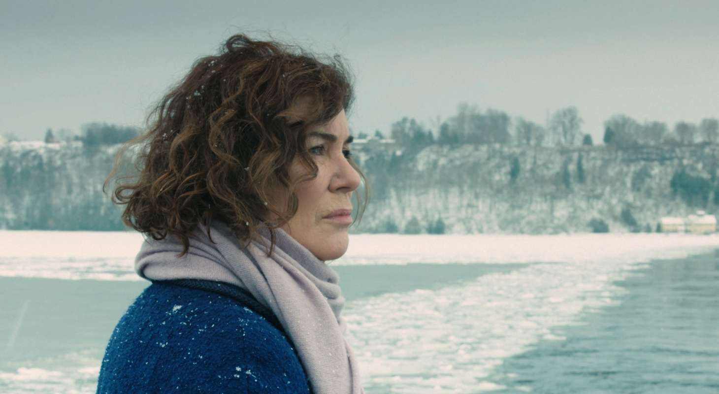 Woman in snowy landscape drifitng snow