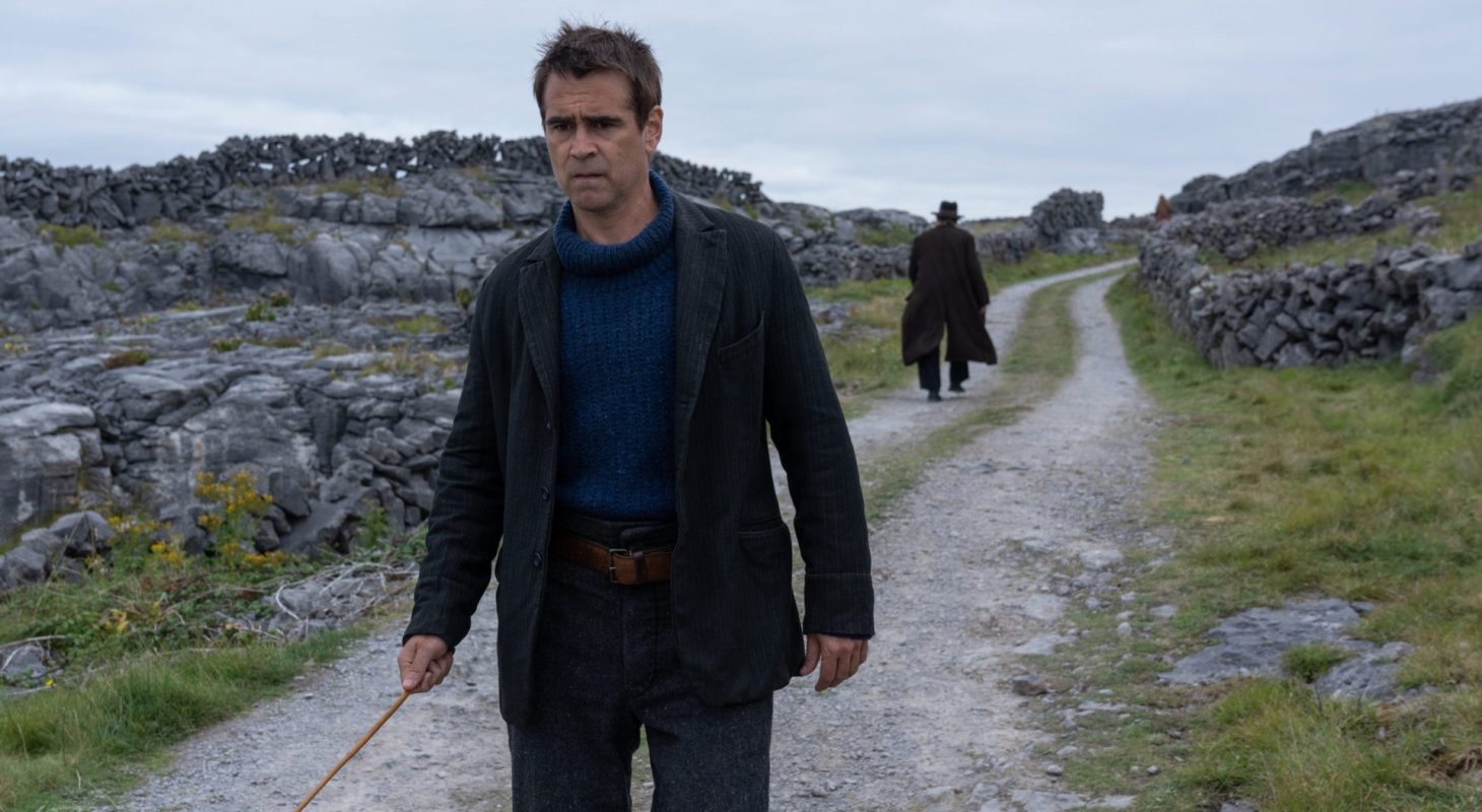 The Banshees of Inisherin still with Colin Farrell walking toward camera and Brendan Gleeson walking away in the distance on a gray Irish dirt road