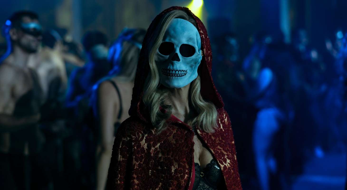 A mysterious woman with a skull mask.