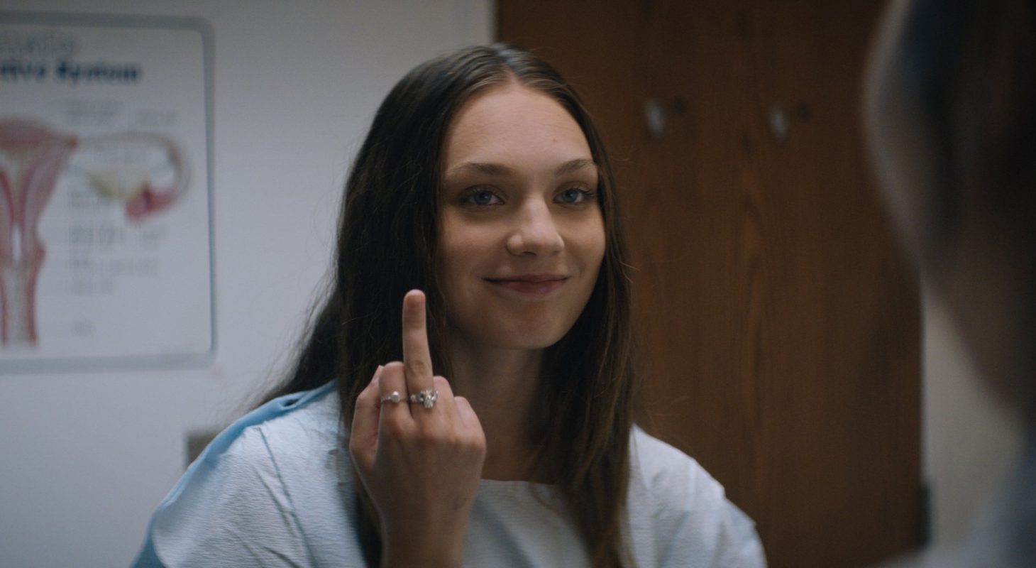 Lindy (Maddy Ziegler) gives the finger to a man in a doctor's office