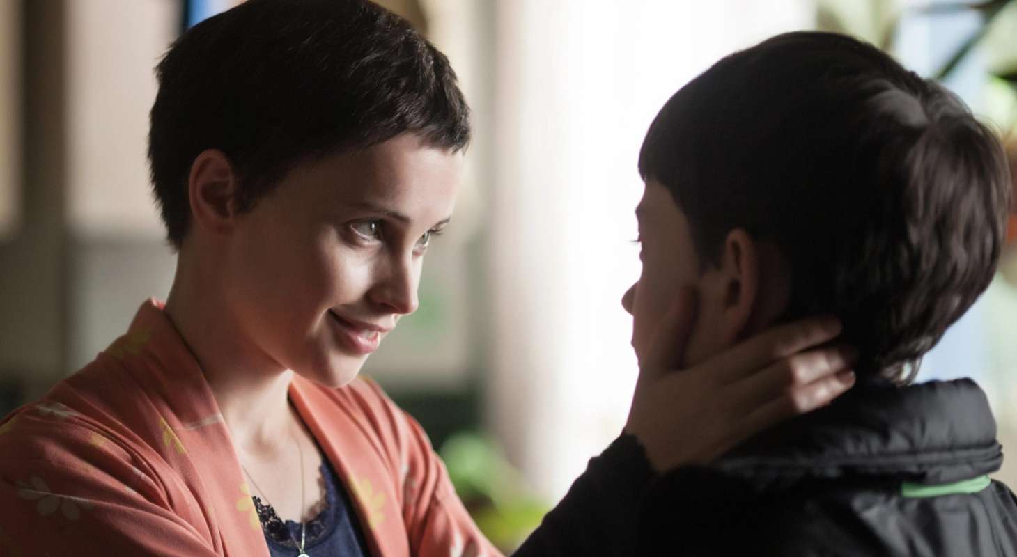 Mom (Felicity Jones) holds the face of her son Conor (Lewis MacDougall)