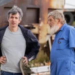 Nathan Fielder stands on an airport tarmac in an episode of the Rehearsal