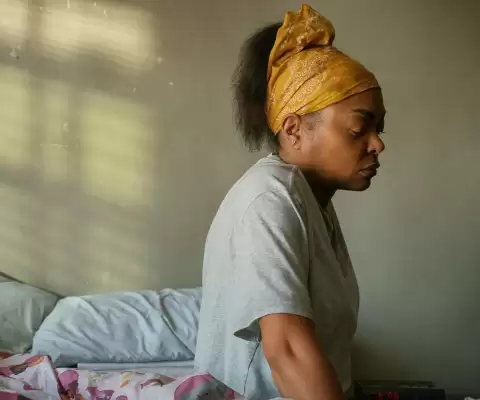 Taraji P. Henson sits on a bed next to her daughter.