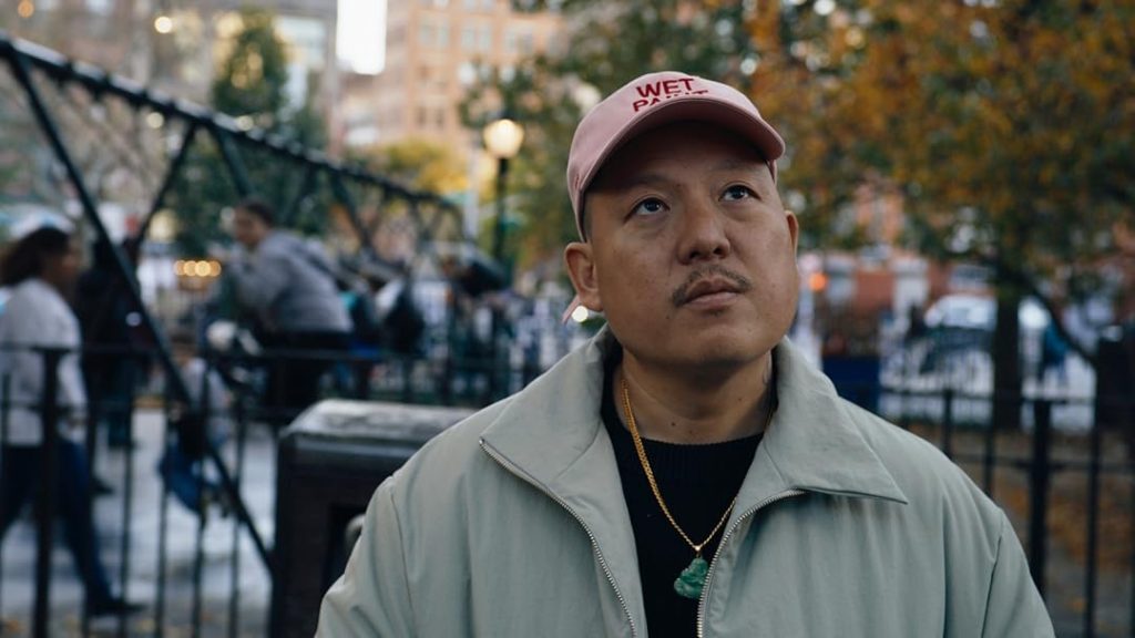 Director Eddie Huang walking down the street in a scene from VICE IS BROKE