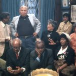 Sitting (left to right): Thomas Harvey, William Patterson, John Henrik Clarke, Mrs. J.B Matthews, Louise Patterson. Standing (left to right): Ernest Chrichlow, Romare Bearden, Ida Mae Cullen. | Photo by Bruce Stanford (1972), courtesy William Greaves Productions