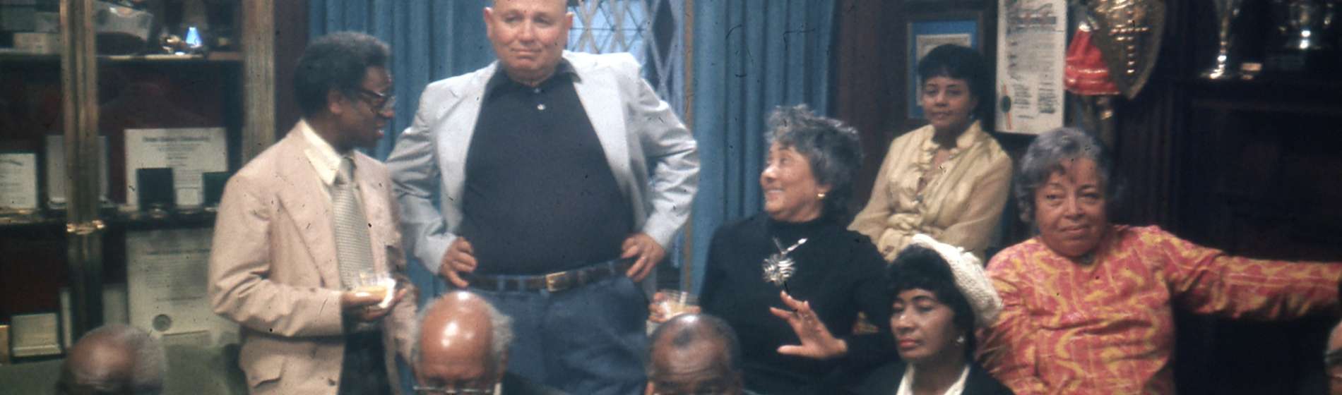 Sitting (left to right): Thomas Harvey, William Patterson, John Henrik Clarke, Mrs. J.B Matthews, Louise Patterson. Standing (left to right): Ernest Chrichlow, Romare Bearden, Ida Mae Cullen. | Photo by Bruce Stanford (1972), courtesy William Greaves Productions