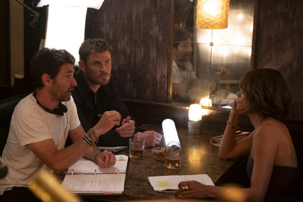Director Bart Layton, Chris Hemsworth and Halle Berry on the set of Crime 101. Photo Credit: Merrick Morton