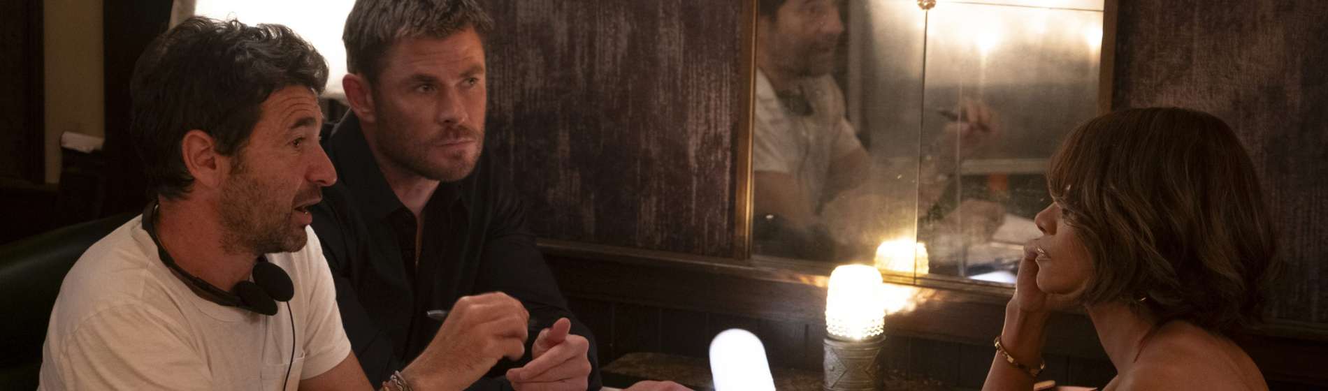 Director Bart Layton, Chris Hemsworth and Halle Berry on the set of Crime 101. Photo Credit: Merrick Morton